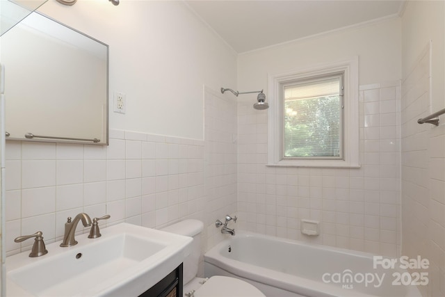 bathroom with vanity, bathtub / shower combination, toilet, tile walls, and ornamental molding