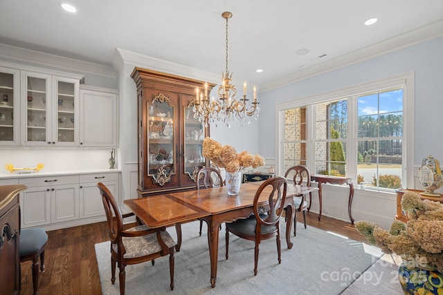 dining space with ornamental molding, visible vents, wood finished floors, and a chandelier