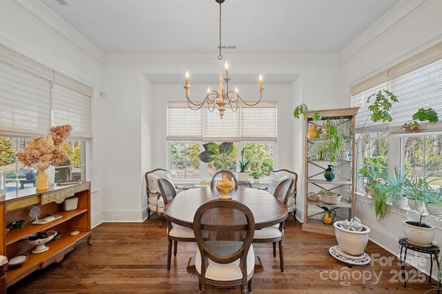 dining area with a chandelier, dark wood finished floors, and baseboards