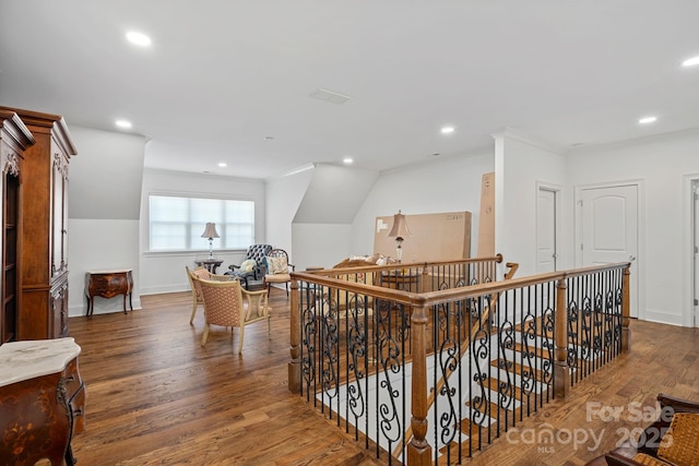 hall with an upstairs landing, wood finished floors, recessed lighting, and baseboards