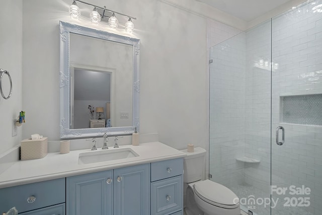 full bathroom featuring ornamental molding, a shower stall, toilet, and vanity