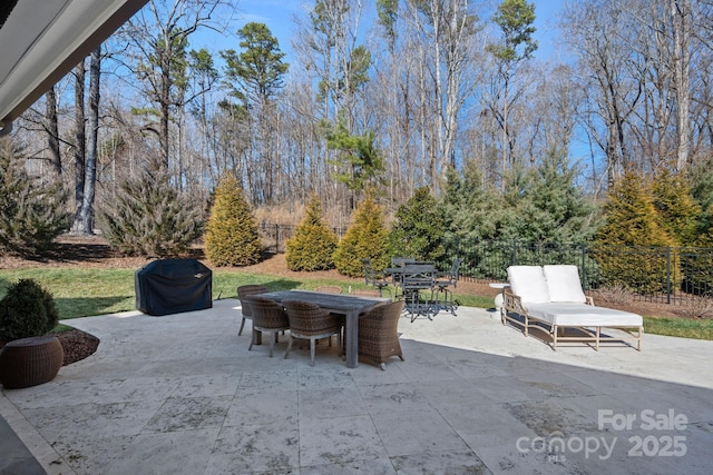 view of patio / terrace with outdoor dining space and fence