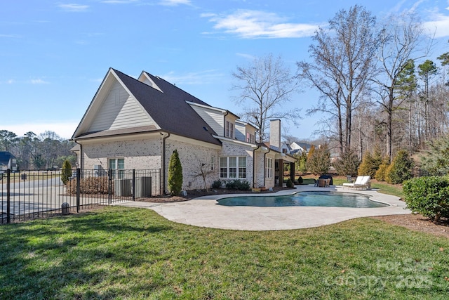 view of swimming pool with a fenced in pool, a patio, a yard, and fence