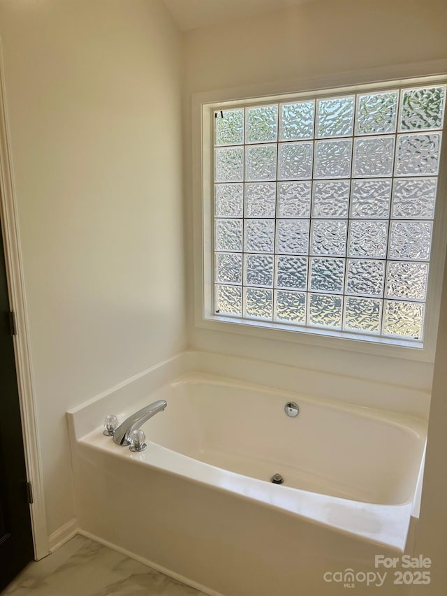 3776 Kennedy Rd, Gastonia, NC 28056 - bathroom with a garden tub, marble finish floor, and a healthy amount of sunlight