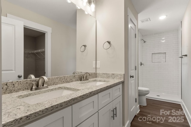 438 Forest Lake Rd, Forest City, NC 28043 - bathroom featuring wood finished floors, a sink, a stall shower, and double vanity