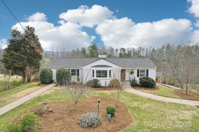 ranch-style home with a chimney and a front lawn