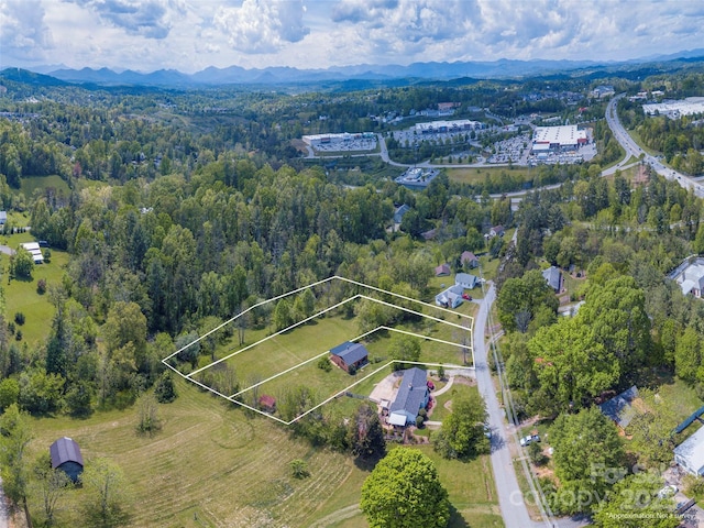 64 Alexander Rd, Weaverville, NC 28787 - aerial view of property and surrounding area with property boundaries highlighted, a mountainous background, and a forest