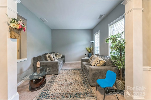 carpeted living room featuring visible vents and baseboards