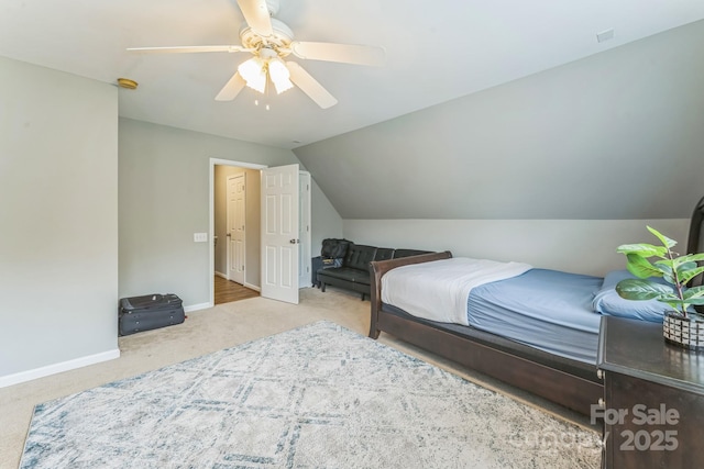 carpeted bedroom with baseboards, a ceiling fan, and vaulted ceiling