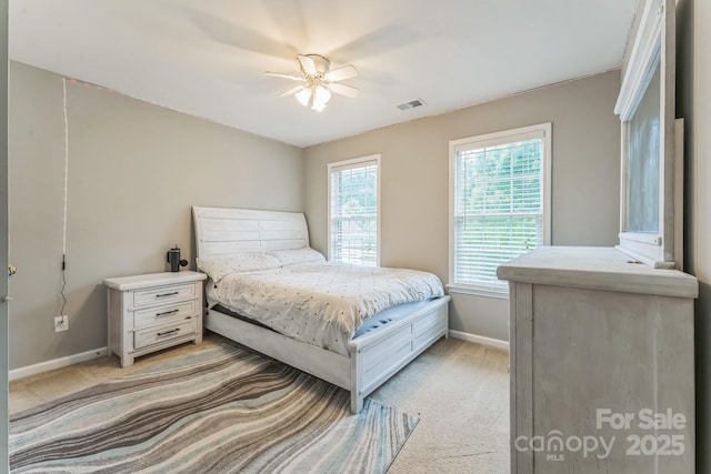 bedroom featuring light carpet, baseboards, and visible vents