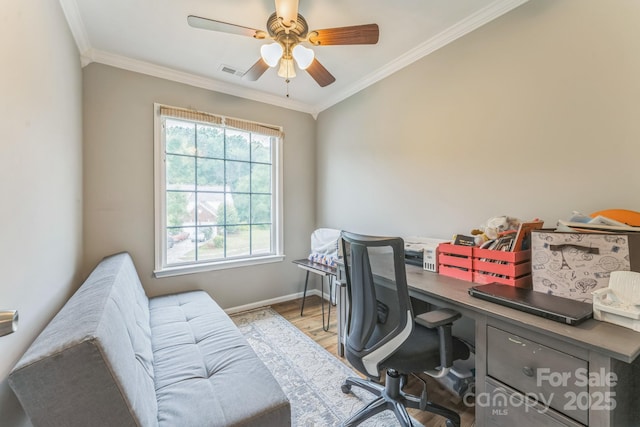 office featuring crown molding, ceiling fan, light wood-type flooring, and visible vents
