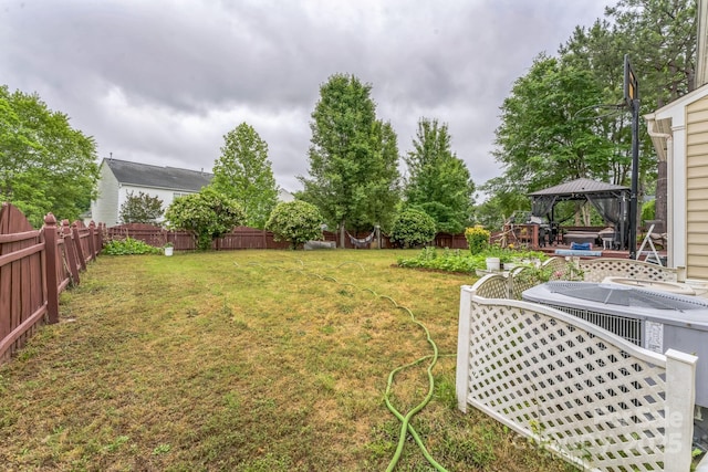 view of yard featuring a fenced backyard and a gazebo