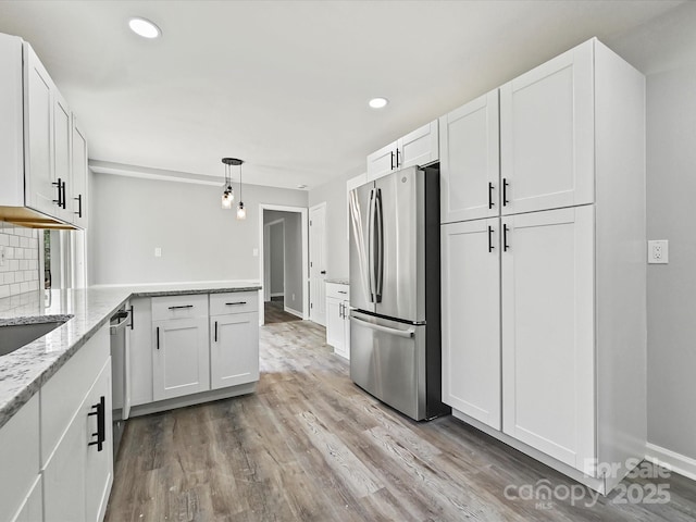 2544 Cedarwild Rd, Charlotte, NC 28212 - kitchen featuring light stone counters, white cabinets, stainless steel appliances, and light wood-type flooring