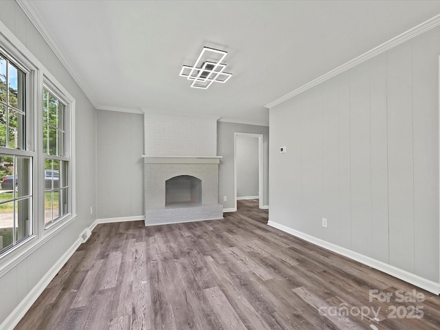2544 Cedarwild Rd, Charlotte, NC 28212 - unfurnished living room with crown molding, wood finished floors, a healthy amount of sunlight, and a fireplace
