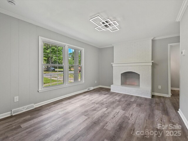 2544 Cedarwild Rd, Charlotte, NC 28212 - unfurnished living room featuring visible vents, a brick fireplace, crown molding, and wood finished floors