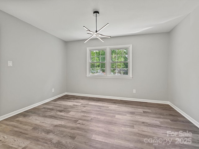 2544 Cedarwild Rd, Charlotte, NC 28212 - empty room featuring baseboards, wood finished floors, and a notable chandelier
