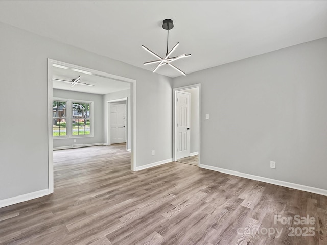 2544 Cedarwild Rd, Charlotte, NC 28212 - spare room featuring baseboards, wood finished floors, and a chandelier