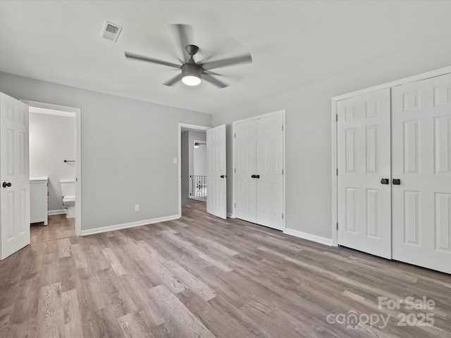 2544 Cedarwild Rd, Charlotte, NC 28212 - unfurnished bedroom featuring multiple closets, visible vents, baseboards, and light wood finished floors