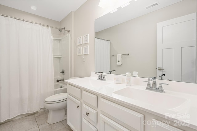 full bath featuring visible vents, double vanity, toilet, tile patterned floors, and a sink