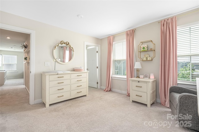 bedroom featuring baseboards and light carpet