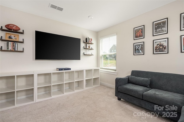 carpeted living room with baseboards and visible vents