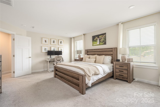 carpeted bedroom featuring baseboards and visible vents