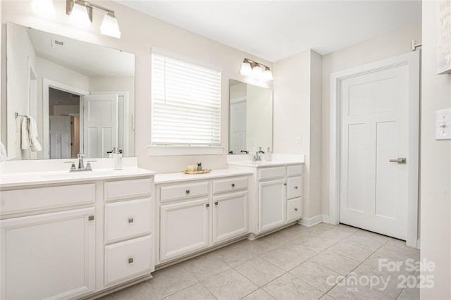 full bathroom featuring double vanity, a sink, and tile patterned flooring