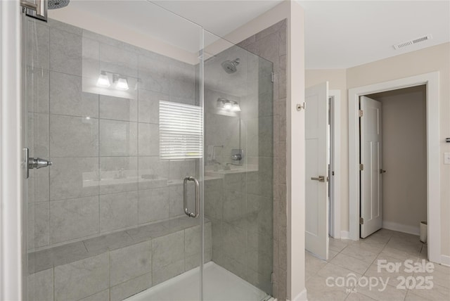 full bath featuring baseboards, visible vents, tile patterned flooring, and a stall shower