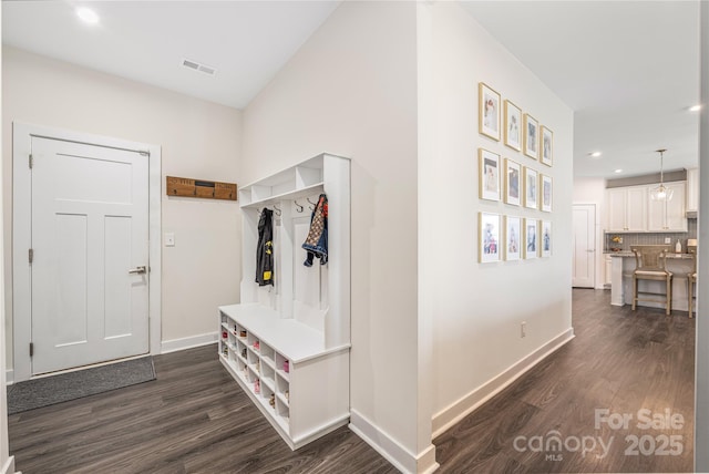 mudroom featuring recessed lighting, baseboards, visible vents, and dark wood finished floors