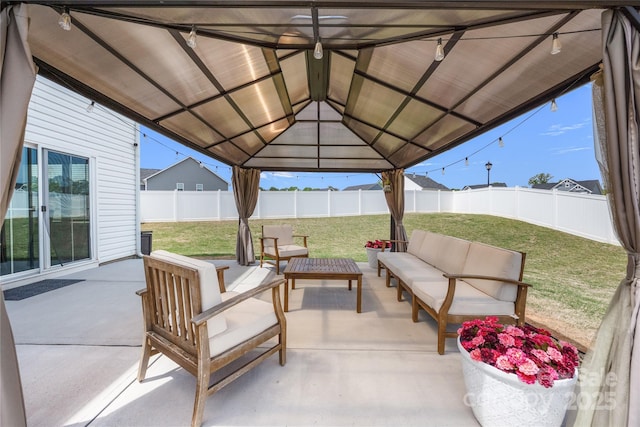 view of patio / terrace featuring a fenced backyard, a gazebo, and an outdoor living space