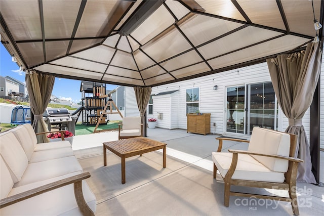 view of patio / terrace with a gazebo, a playground, and a grill