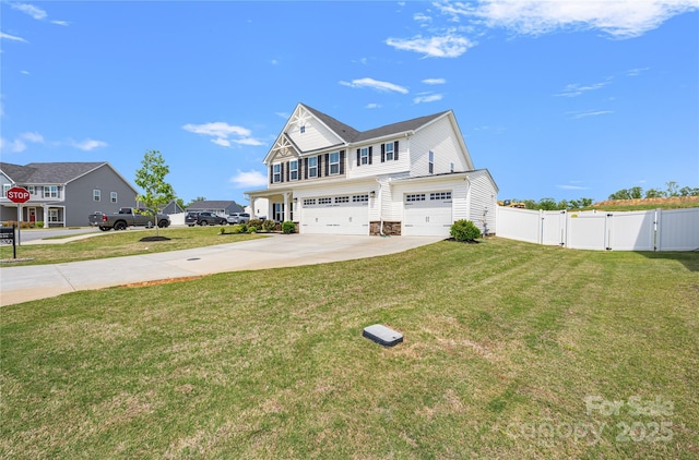 view of front of house featuring a front yard, a gate, fence, concrete driveway, and an attached garage