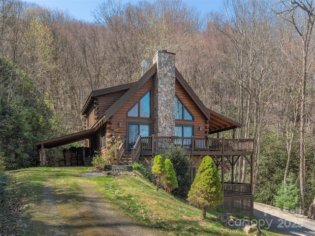 90 Junco Trl, Waynesville, NC 28785 - view of front of home with a deck, a chimney, a forest view, and log siding