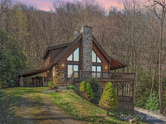90 Junco Trl, Waynesville, NC 28785 - view of front of house featuring a chimney, a wooded view, and log exterior