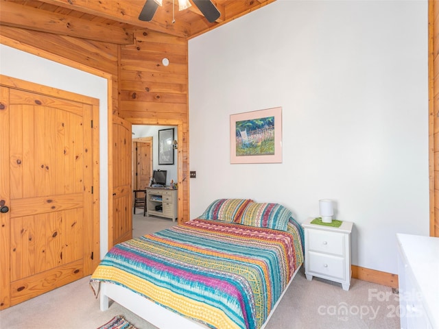 90 Junco Trl, Waynesville, NC 28785 - bedroom with wood walls, ceiling fan, and light colored carpet