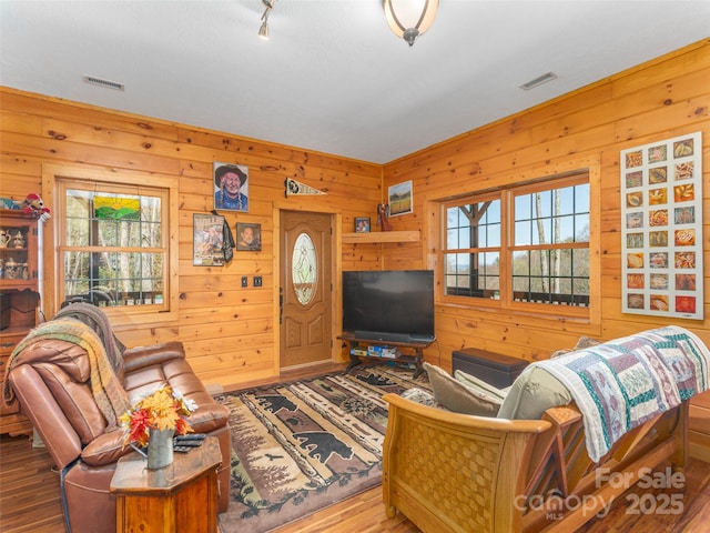 90 Junco Trl, Waynesville, NC 28785 - living room with wooden walls, visible vents, and wood finished floors
