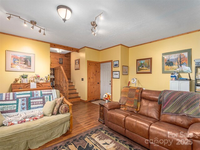 90 Junco Trl, Waynesville, NC 28785 - living area featuring wood finished floors, rail lighting, wood walls, ornamental molding, and stairway