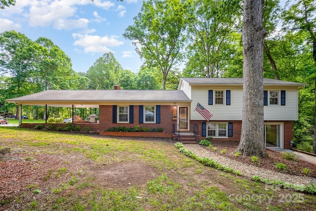 tri-level home featuring brick siding and a chimney