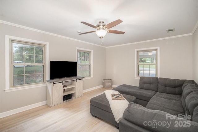living area featuring baseboards, light wood-style floors, a ceiling fan, and ornamental molding
