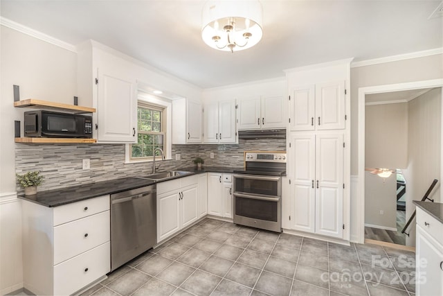 kitchen with appliances with stainless steel finishes, a sink, under cabinet range hood, dark countertops, and backsplash