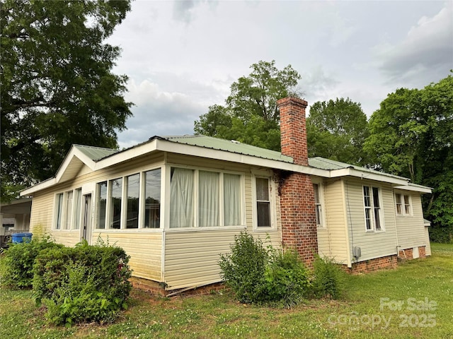 1703 Lowder St, Albemarle, NC 28001 - exterior space featuring a chimney, a yard, and metal roof