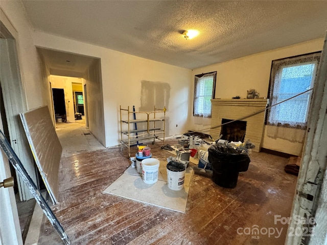 1703 Lowder St, Albemarle, NC 28001 - interior space with a fireplace, wood-type flooring, and a textured ceiling