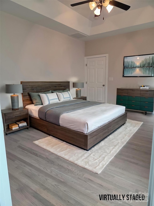 bedroom with wood finished floors and a ceiling fan