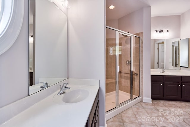 full bathroom with a stall shower, tile patterned flooring, two vanities, and recessed lighting