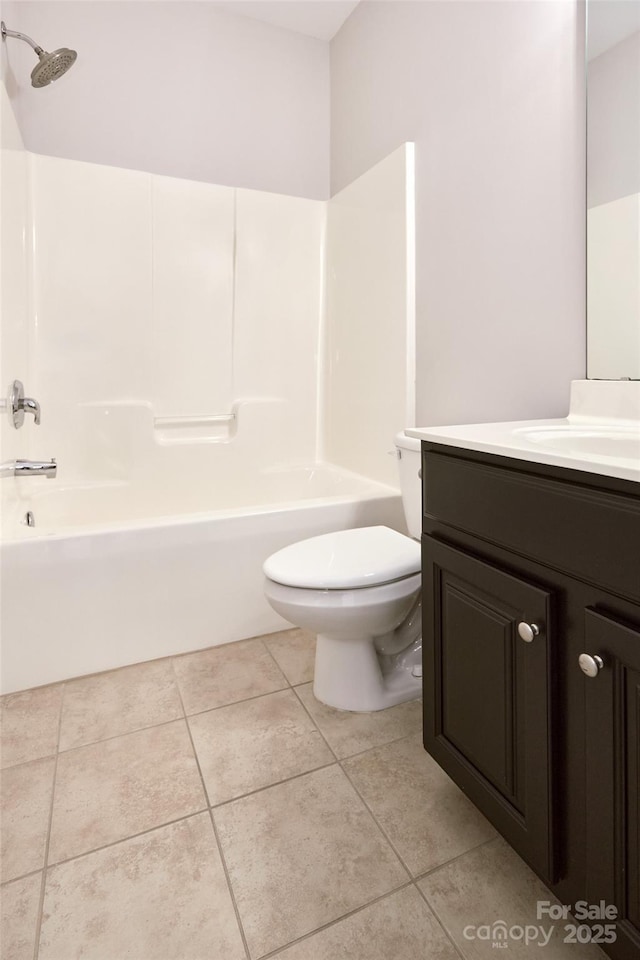 bathroom featuring tile patterned floors, toilet, washtub / shower combination, and vanity