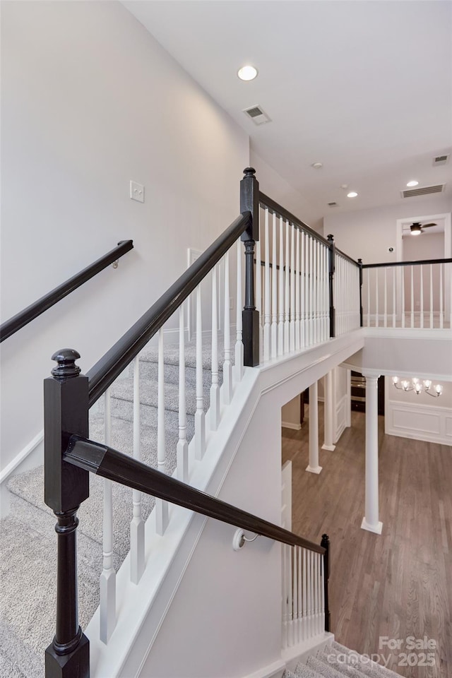 stairway featuring wood finished floors, recessed lighting, and ceiling fan