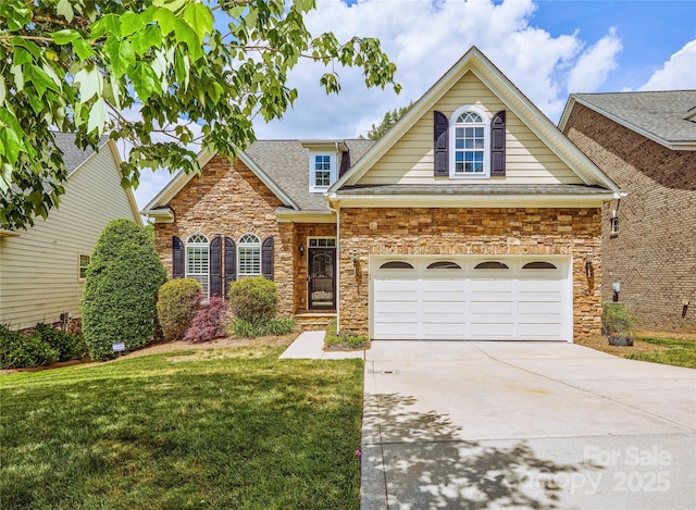 view of front of house featuring a front yard, stone siding, concrete driveway, and a shingled roof