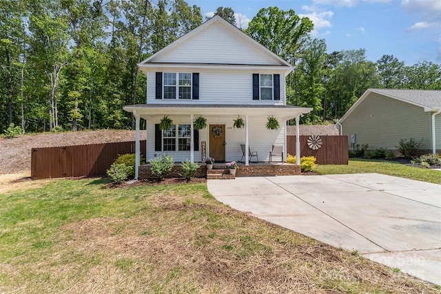 658 Morgan Rd, Albemarle, NC 28001 - view of front facade featuring covered porch, fence, and a front lawn