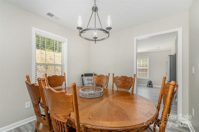 658 Morgan Rd, Albemarle, NC 28001 - dining area featuring a notable chandelier, visible vents, baseboards, and light wood-type flooring
