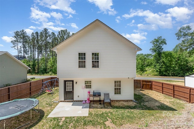 658 Morgan Rd, Albemarle, NC 28001 - back of house with a patio, a fenced backyard, a trampoline, and a yard
